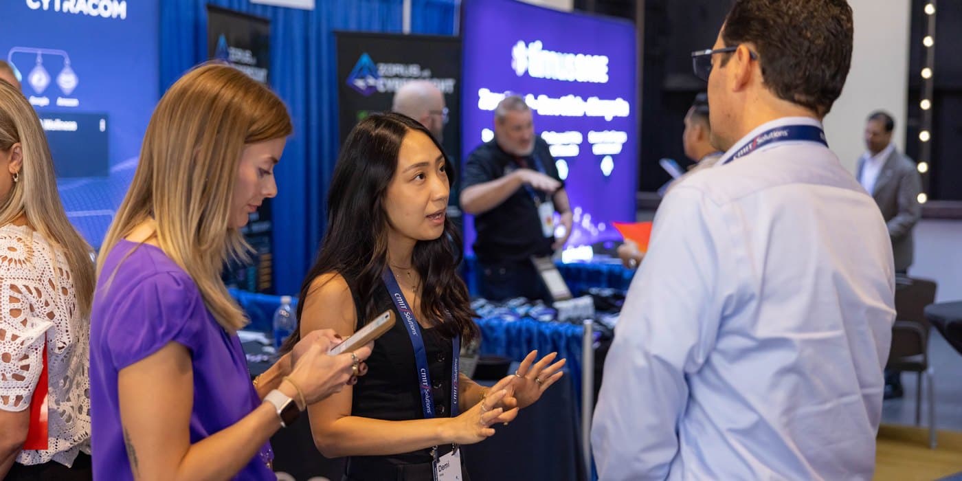 Jorge talking with a vendor at the CMIT expo