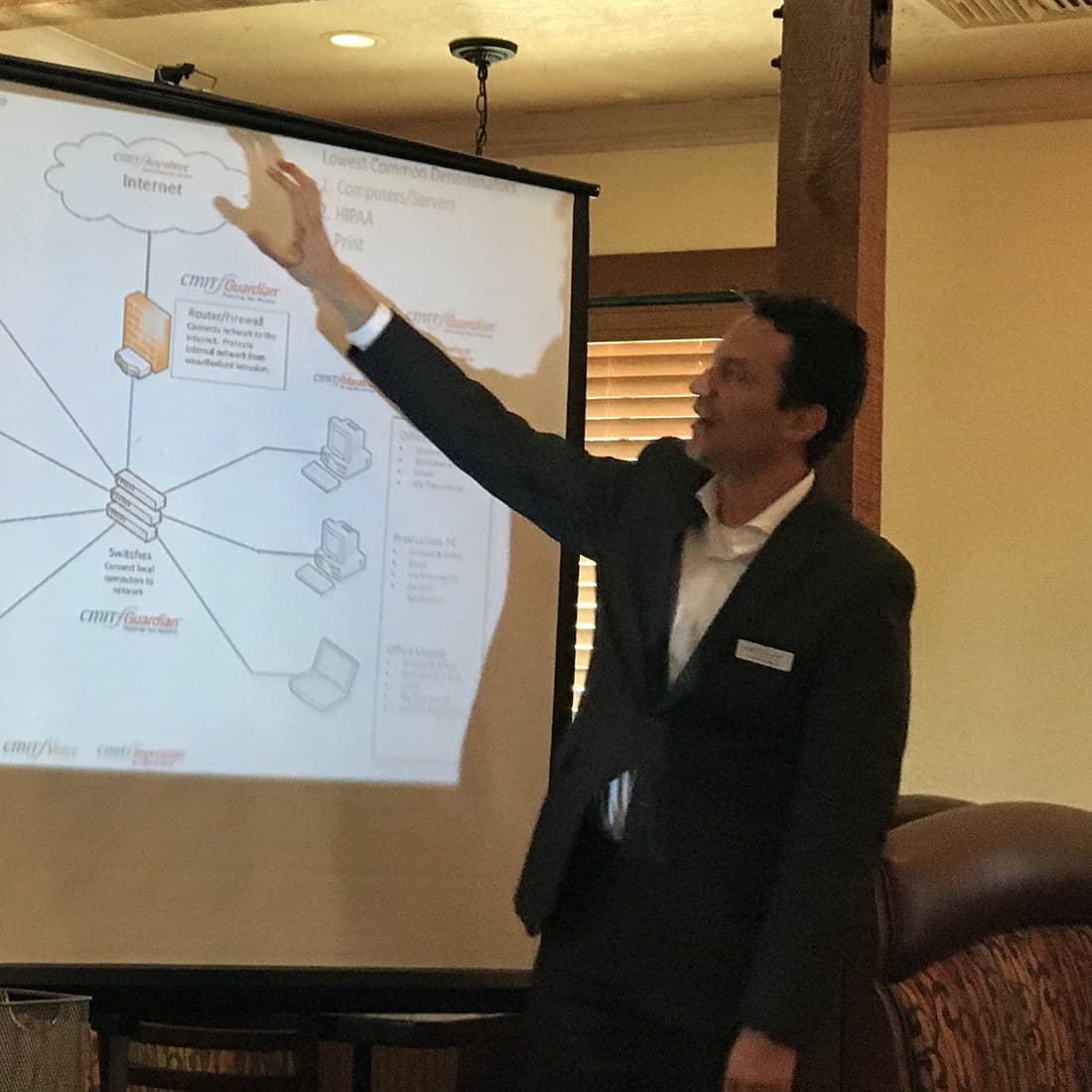 Jorge walking a room of Austin business owners through a network diagram